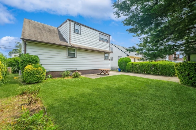 66 Gates Ave, Valley Stream, NY 11580 - back of property featuring a yard, a patio area, and a shingled roof