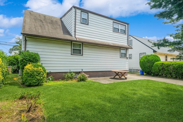 66 Gates Ave, Valley Stream, NY 11580 - rear view of property with a yard, a patio, and a shingled roof