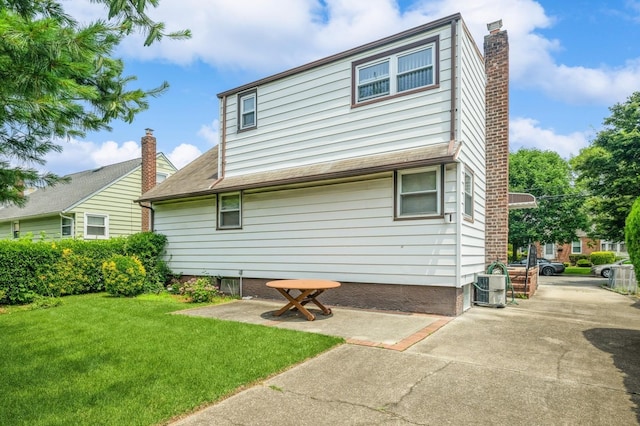 66 Gates Ave, Valley Stream, NY 11580 - back of house featuring a yard, a chimney, and a patio area