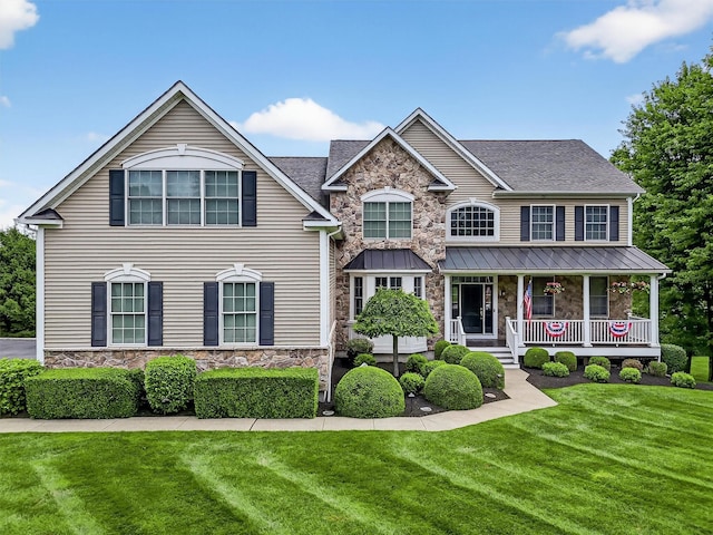 36 Ballymeade Rd, Hopewell Junction, NY 12533 - view of front of home featuring stone siding, covered porch, a front yard, and a shingled roof
