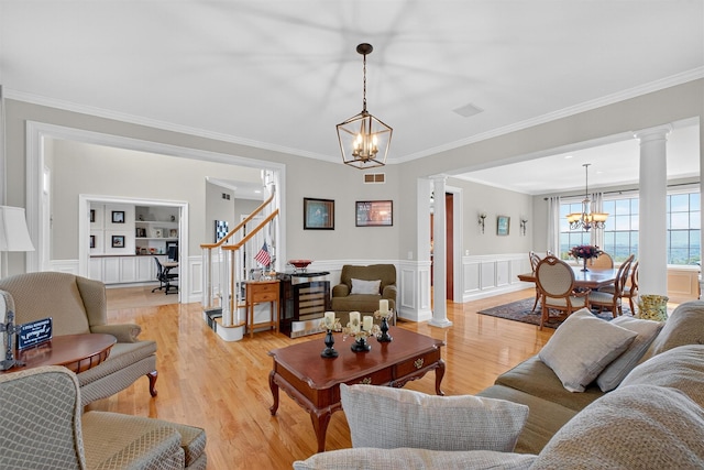 36 Ballymeade Rd, Hopewell Junction, NY 12533 - living room with a chandelier, ornate columns, stairs, light wood-type flooring, and ornamental molding