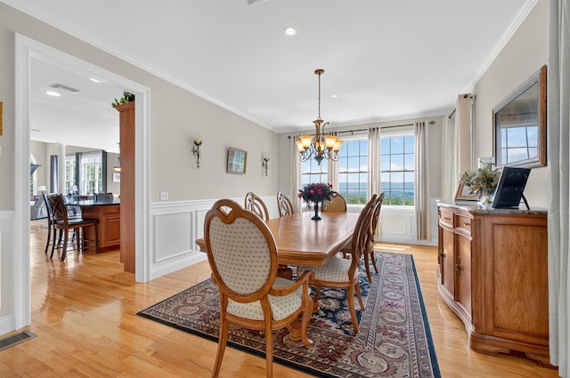 36 Ballymeade Rd, Hopewell Junction, NY 12533 - dining space featuring crown molding, healthy amount of natural light, a chandelier, a wainscoted wall, and light wood-style floors