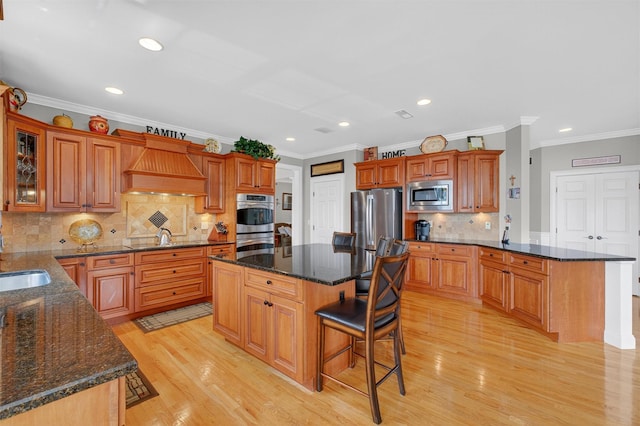 36 Ballymeade Rd, Hopewell Junction, NY 12533 - kitchen featuring stainless steel appliances, custom exhaust hood, a breakfast bar area, light wood finished floors, and recessed lighting