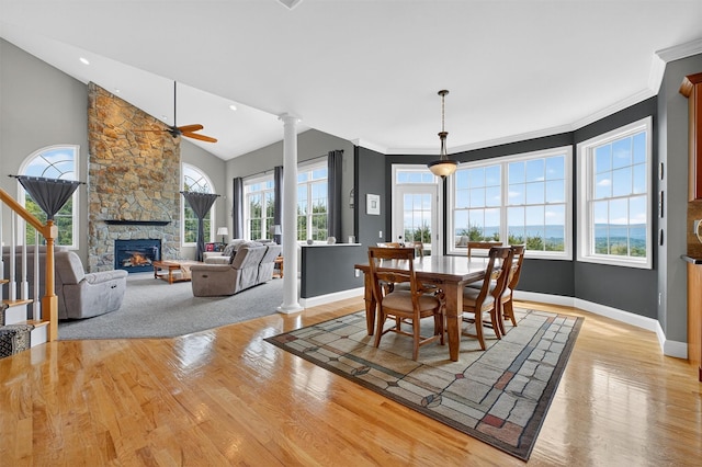 36 Ballymeade Rd, Hopewell Junction, NY 12533 - dining space with a stone fireplace, light wood-style flooring, ornate columns, vaulted ceiling, and ceiling fan