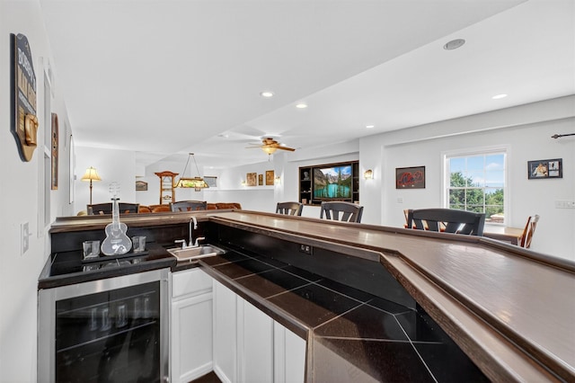 36 Ballymeade Rd, Hopewell Junction, NY 12533 - kitchen with beverage cooler, dark countertops, white cabinets, open floor plan, and recessed lighting