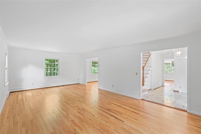 21 Kipp St, Chappaqua, NY 10514 - unfurnished room featuring a baseboard heating unit, crown molding, healthy amount of natural light, a chandelier, and stairs