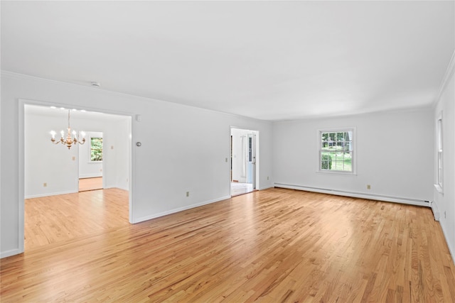 21 Kipp St, Chappaqua, NY 10514 - spare room featuring baseboard heating, a chandelier, light wood-style flooring, and crown molding