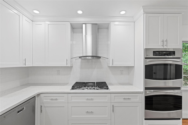21 Kipp St, Chappaqua, NY 10514 - kitchen with stainless steel appliances, wall chimney exhaust hood, white cabinetry, decorative backsplash, and recessed lighting