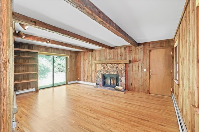 21 Kipp St, Chappaqua, NY 10514 - unfurnished living room with a baseboard heating unit, wood walls, light wood-style floors, beamed ceiling, and a stone fireplace