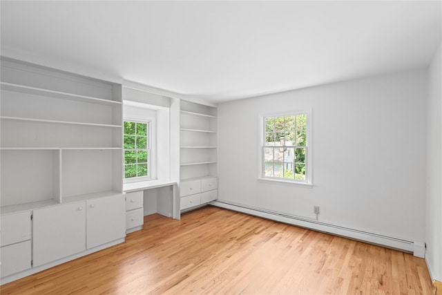 21 Kipp St, Chappaqua, NY 10514 - spare room featuring baseboard heating, healthy amount of natural light, light wood-type flooring, and built in features