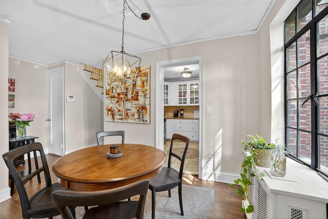 20 N Broadway Unit O-373, White Plains, NY 10601 - dining space featuring dark wood-style floors, stairway, crown molding, and a chandelier