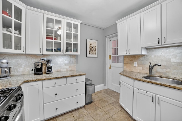20 N Broadway Unit O-373, White Plains, NY 10601 - kitchen featuring stainless steel gas stove, backsplash, and white cabinets