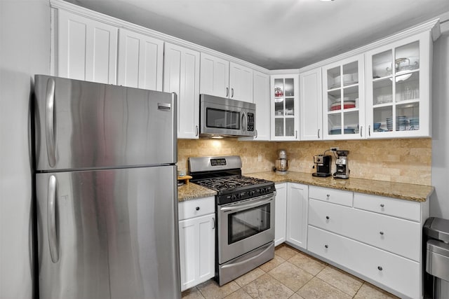 20 N Broadway Unit O-373, White Plains, NY 10601 - kitchen featuring appliances with stainless steel finishes, decorative backsplash, and white cabinetry