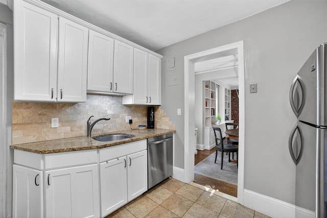 20 N Broadway Unit O-373, White Plains, NY 10601 - kitchen featuring appliances with stainless steel finishes, light stone counters, tasteful backsplash, and white cabinetry
