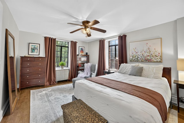 20 N Broadway Unit O-373, White Plains, NY 10601 - bedroom featuring radiator heating unit, wood finished floors, and a ceiling fan