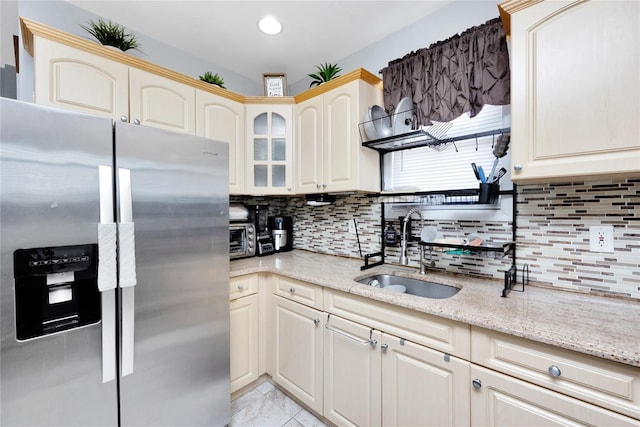 12311 115th Ave, South Ozone Park, NY 11420 - kitchen with stainless steel fridge, tasteful backsplash, glass insert cabinets, and light stone counters