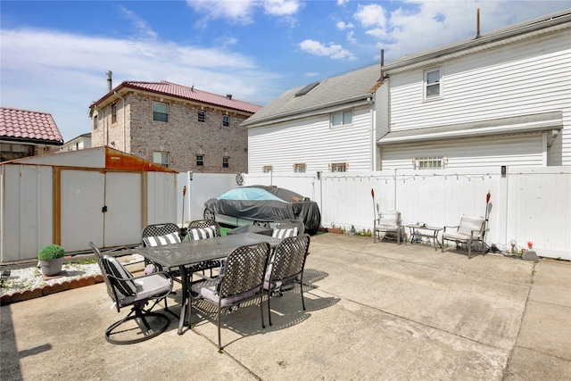 12311 115th Ave, South Ozone Park, NY 11420 - fenced backyard featuring a storage shed, a patio area, and outdoor dining area