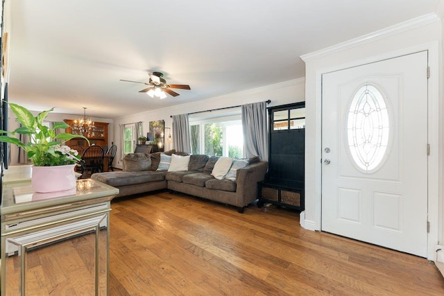 2691 Evans Rd, Oceanside, NY 11572 - living area with a ceiling fan, a chandelier, crown molding, and light wood-style flooring