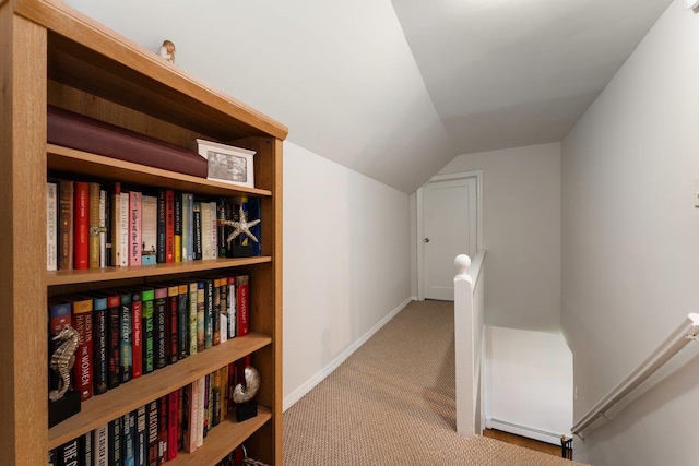 2691 Evans Rd, Oceanside, NY 11572 - hall with an upstairs landing, carpet flooring, vaulted ceiling, and a baseboard radiator