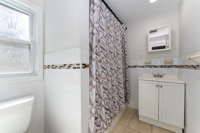 2691 Evans Rd, Oceanside, NY 11572 - bathroom with tile walls, tile patterned flooring, plenty of natural light, vanity, and a shower with curtain