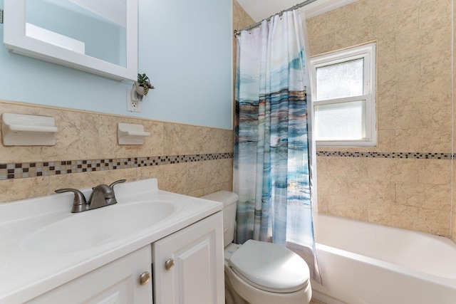 2691 Evans Rd, Oceanside, NY 11572 - bathroom featuring vanity, tile walls, shower / bathtub combination with curtain, and wainscoting