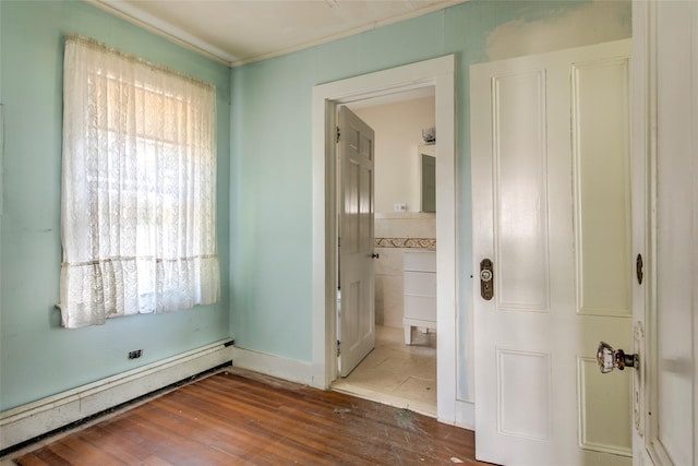 2 Shore Rd, East Setauket, NY 11733 - unfurnished bedroom with a baseboard radiator and wood finished floors