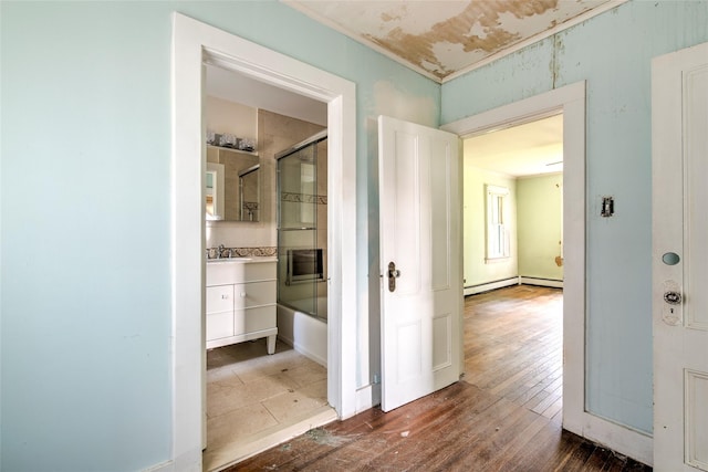 2 Shore Rd, East Setauket, NY 11733 - corridor with hardwood / wood-style flooring and a baseboard radiator