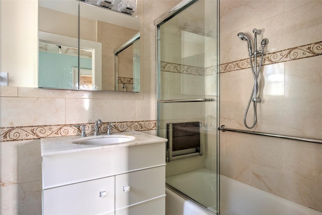 2 Shore Rd, East Setauket, NY 11733 - full bath with combined bath / shower with glass door, vanity, and tile walls