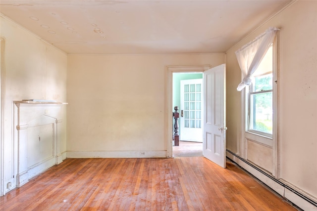 2 Shore Rd, East Setauket, NY 11733 - spare room with baseboard heating, light wood-style floors, and ornamental molding