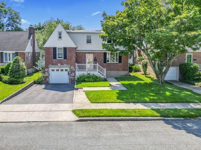 8 Walnut Rd, East Rockaway, NY 11518 - view of front facade with an attached garage, brick siding, driveway, and a front lawn