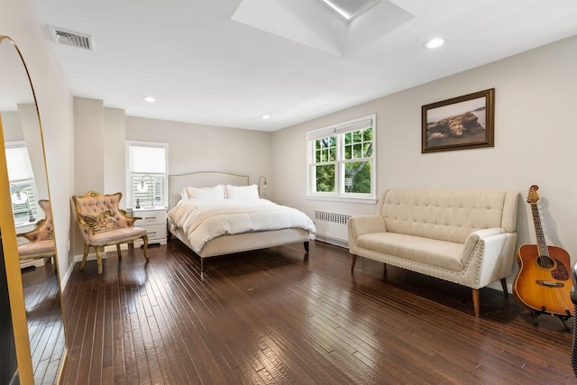 8 Walnut Rd, East Rockaway, NY 11518 - bedroom with radiator heating unit, dark wood-style flooring, and recessed lighting