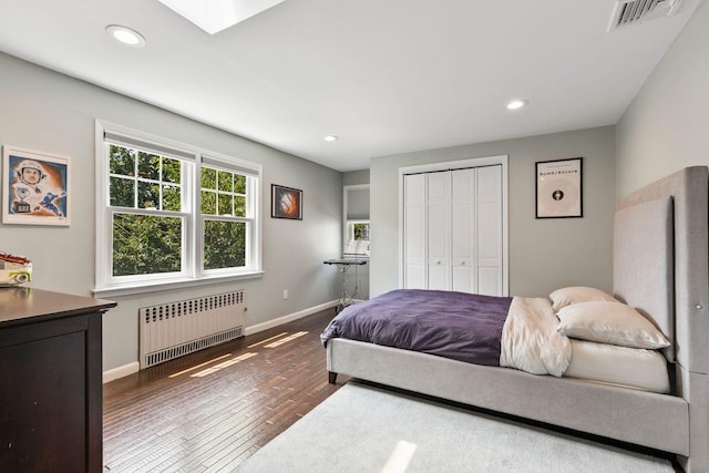 8 Walnut Rd, East Rockaway, NY 11518 - bedroom with radiator, dark wood-type flooring, a closet, and recessed lighting