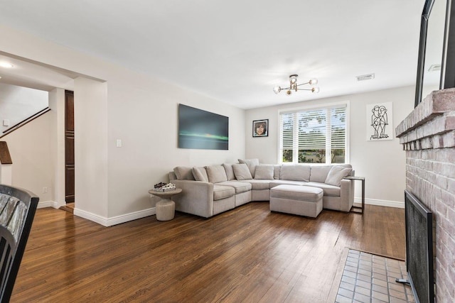 8 Walnut Rd, East Rockaway, NY 11518 - living room featuring a fireplace, dark wood finished floors, and a chandelier