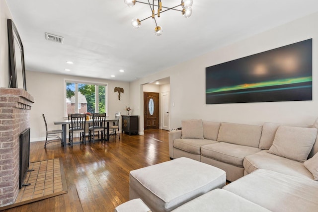 8 Walnut Rd, East Rockaway, NY 11518 - living room with hardwood / wood-style flooring, a brick fireplace, a chandelier, and recessed lighting