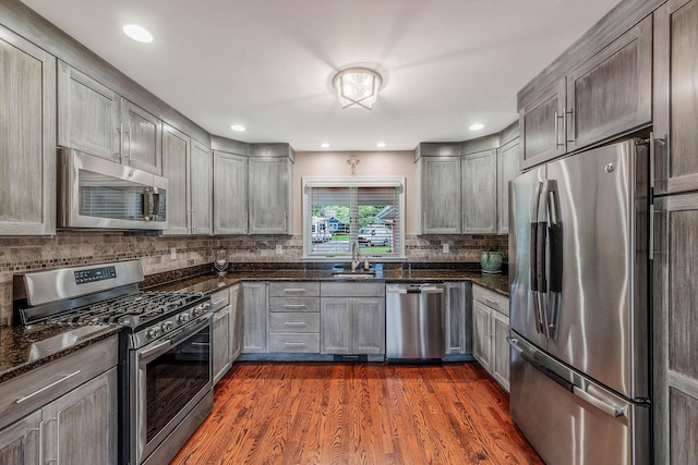 3 Stark Dr, Center Moriches, NY 11934 - kitchen featuring stainless steel appliances, tasteful backsplash, dark wood-style floors, dark stone counters, and recessed lighting