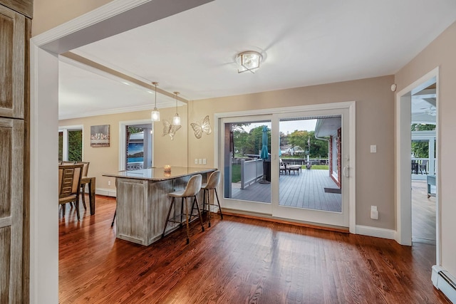 3 Stark Dr, Center Moriches, NY 11934 - kitchen featuring a baseboard radiator, a kitchen breakfast bar, dark wood-type flooring, hanging light fixtures, and a peninsula