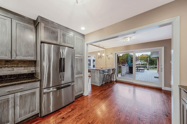 3 Stark Dr, Center Moriches, NY 11934 - kitchen featuring stainless steel fridge, tasteful backsplash, wood finished floors, a chandelier, and recessed lighting
