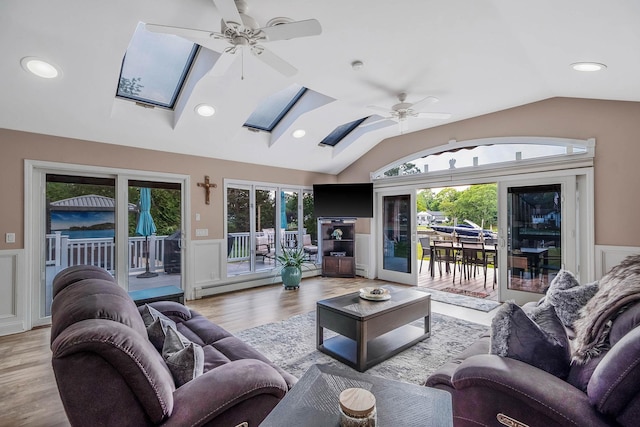 3 Stark Dr, Center Moriches, NY 11934 - living area with a skylight, a ceiling fan, lofted ceiling, wainscoting, and healthy amount of natural light