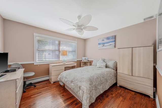 3 Stark Dr, Center Moriches, NY 11934 - bedroom featuring wood finished floors, a baseboard heating unit, a ceiling fan, and a desk