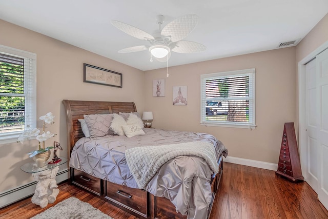 3 Stark Dr, Center Moriches, NY 11934 - bedroom with dark wood finished floors, ceiling fan, and baseboard heating