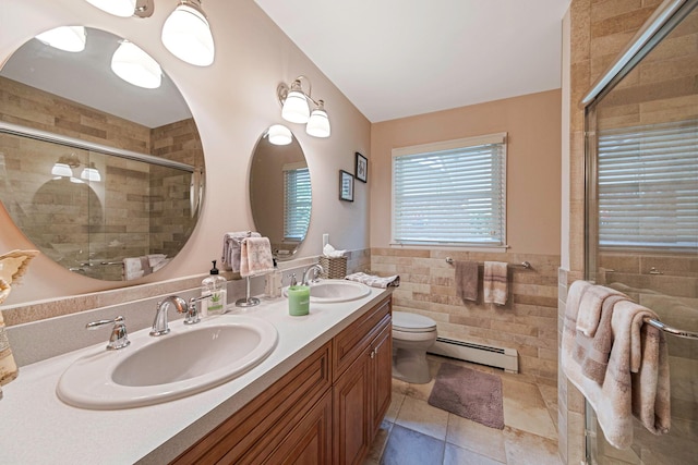 3 Stark Dr, Center Moriches, NY 11934 - full bath with baseboard heating, double vanity, tile walls, tiled shower, and tile patterned flooring