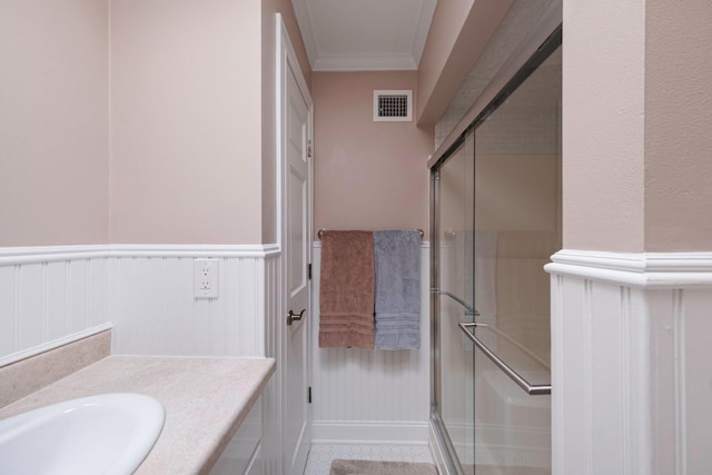 3 Stark Dr, Center Moriches, NY 11934 - bathroom with a shower stall, vanity, wainscoting, ornamental molding, and a decorative wall