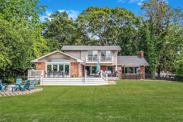 3 Stark Dr, Center Moriches, NY 11934 - rear view of property featuring brick siding, a balcony, a fire pit, a patio area, and a chimney