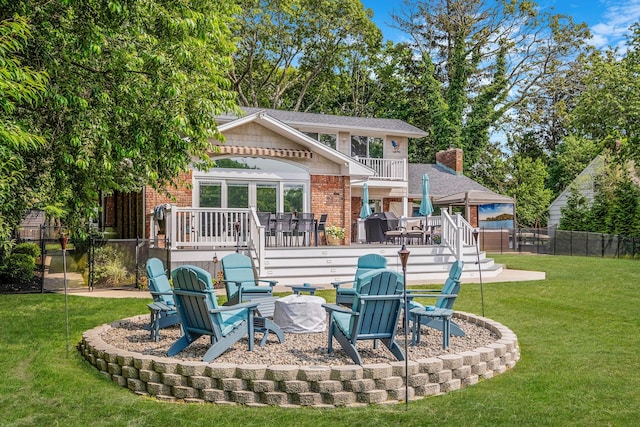 3 Stark Dr, Center Moriches, NY 11934 - back of property with brick siding, a deck, a fire pit, and a patio area