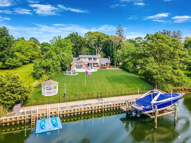 3 Stark Dr, Center Moriches, NY 11934 - rear view of house featuring boat lift, a water view, a fenced backyard, and view of scattered trees