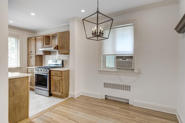 53 Nathan Hale Dr Unit 7A, Huntington, NY 11743 - kitchen with radiator, stainless steel gas stove, a chandelier, crown molding, and light countertops