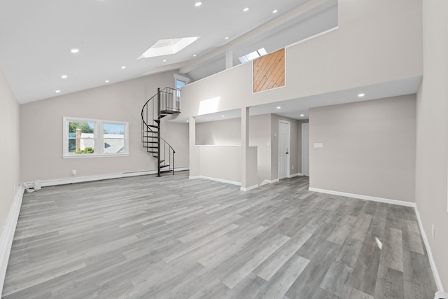 126 Lutz Dr, Valley Stream, NY 11580 - unfurnished living room with recessed lighting, high vaulted ceiling, a skylight, stairway, and wood finished floors