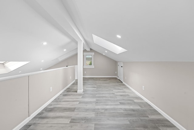 126 Lutz Dr, Valley Stream, NY 11580 - additional living space with a skylight, light wood finished floors, vaulted ceiling, and recessed lighting