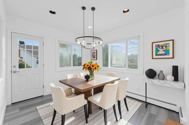 126 Lutz Dr, Valley Stream, NY 11580 - dining room with baseboard heating, a chandelier, light wood finished floors, recessed lighting, and a baseboard radiator