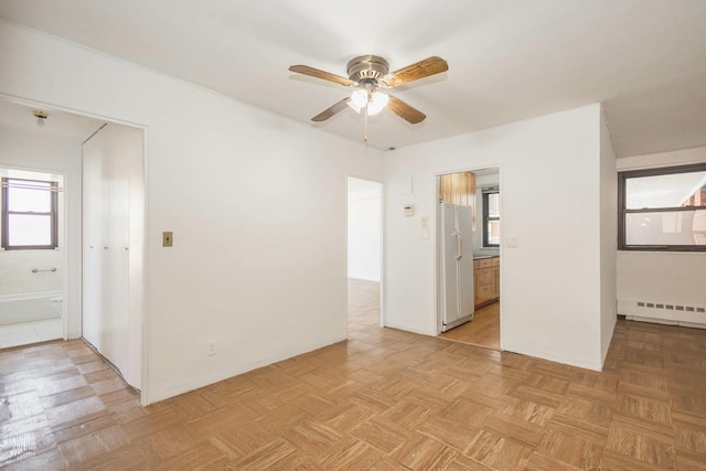 61-25 98th St Unit 11E, Rego Park, NY 11374 - empty room with a ceiling fan and a baseboard heating unit